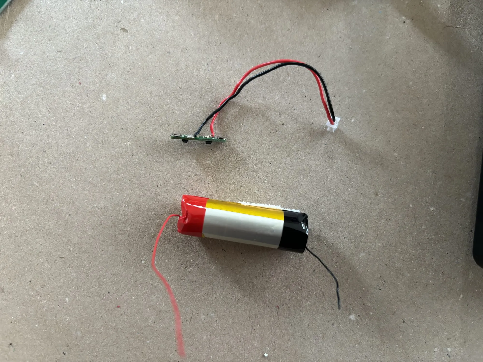 The harvested battery protection circuit with a smaller battery beneath.