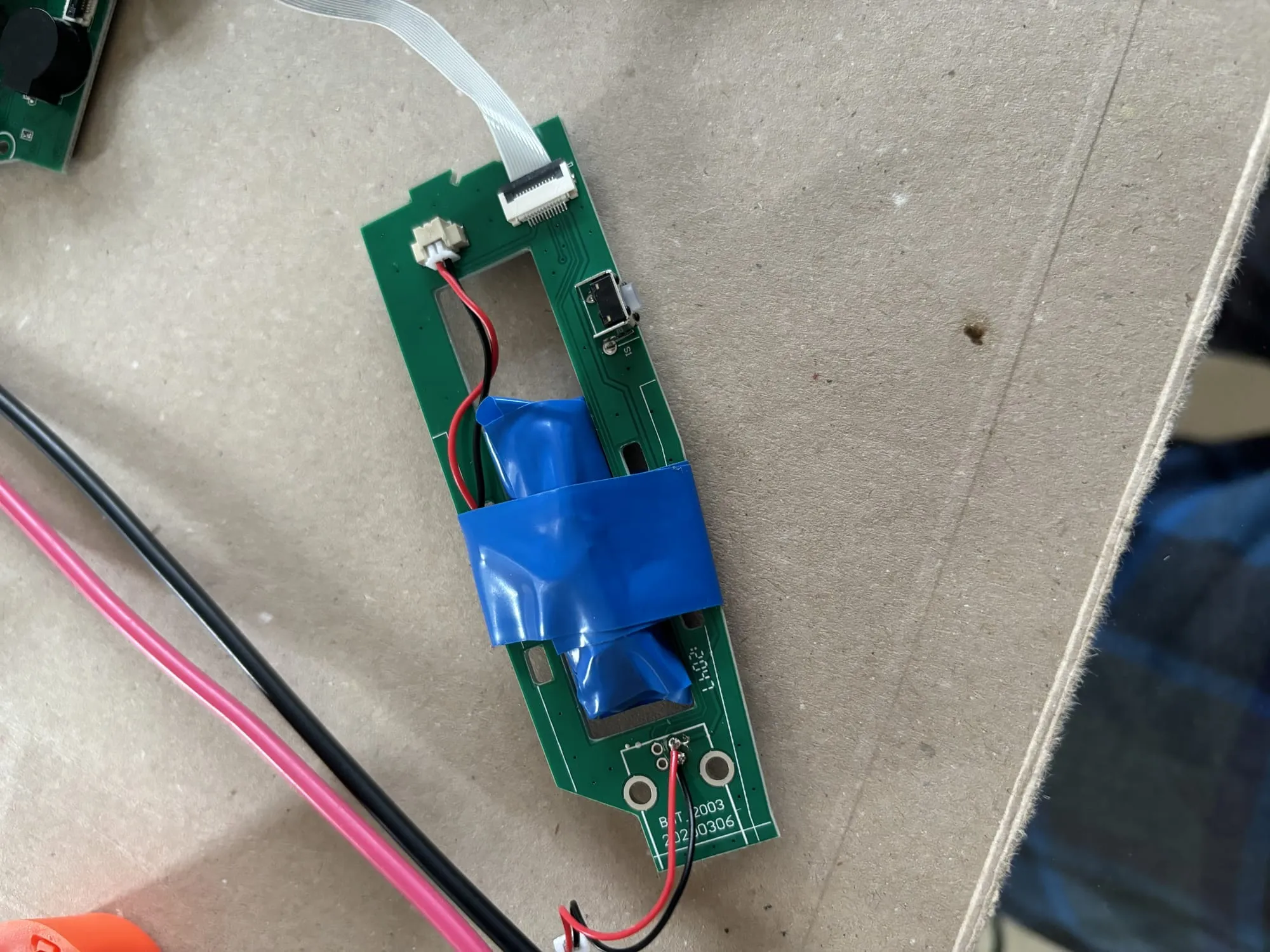 The complete battery (with protection circuit) wrapped in quite a lot of electrical tape and put back onto the original circuit board.