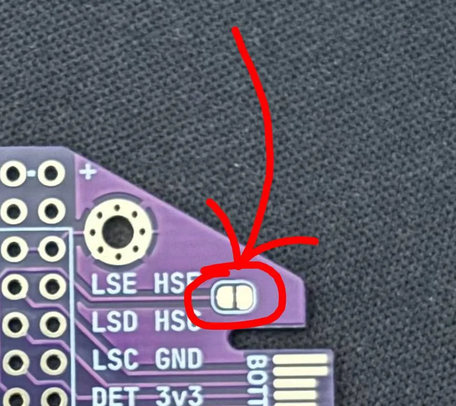 Arrow indicating the jumper pad on bottom of board